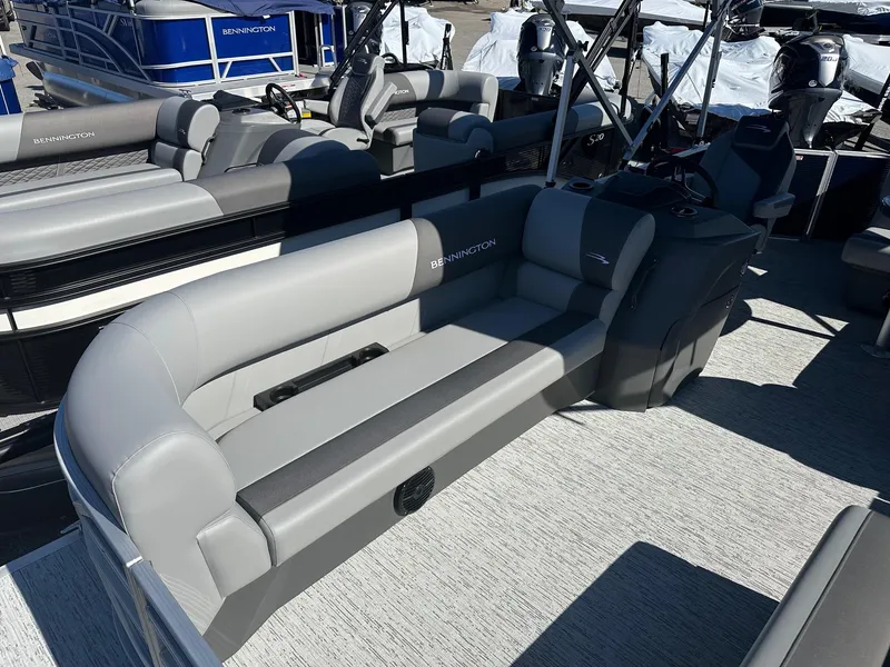 Slide: The Image of 2025 Bennington 20 SL Family pontoon boat interior with privacy room, featuring gray seating. - 26