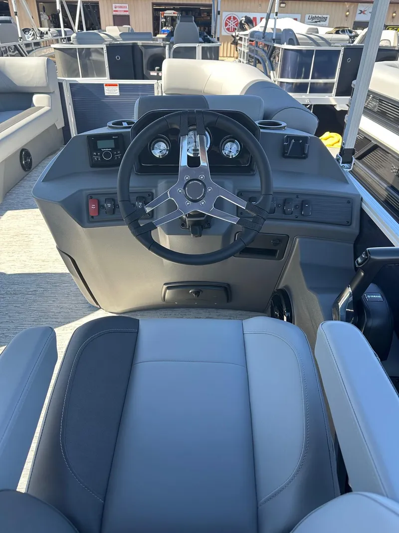 Slide: The Image of 2025 Bennington 20 SL Family boat interior with steering wheel and seating. - 29