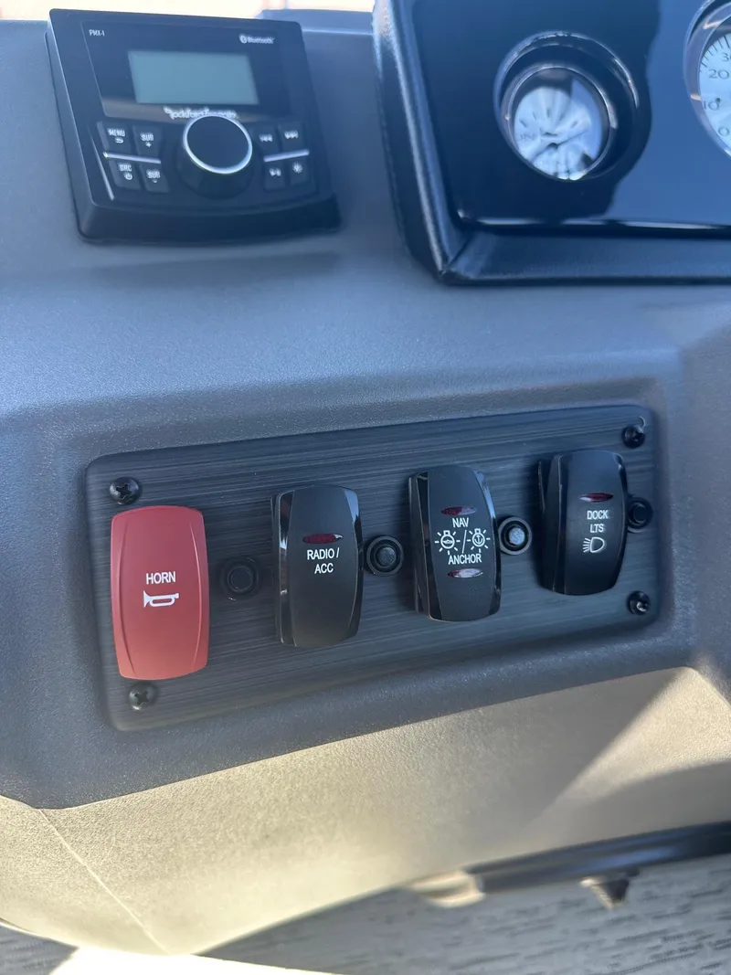 Slide: The Image of Control panel of 2025 Bennington 20 SL Family boat with switches and stereo system. - 31