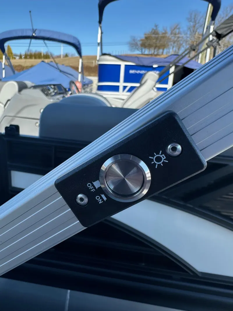 Slide: The Image of 2025 Bennington 20 SL Family boat light switch, close-up view. - 33