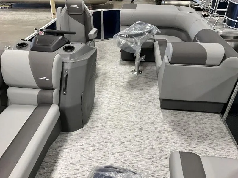 Slide: The Image of 2025 Bennington 20 SL Family pontoon boat interior with privacy room, featuring gray seating and helm. - 39