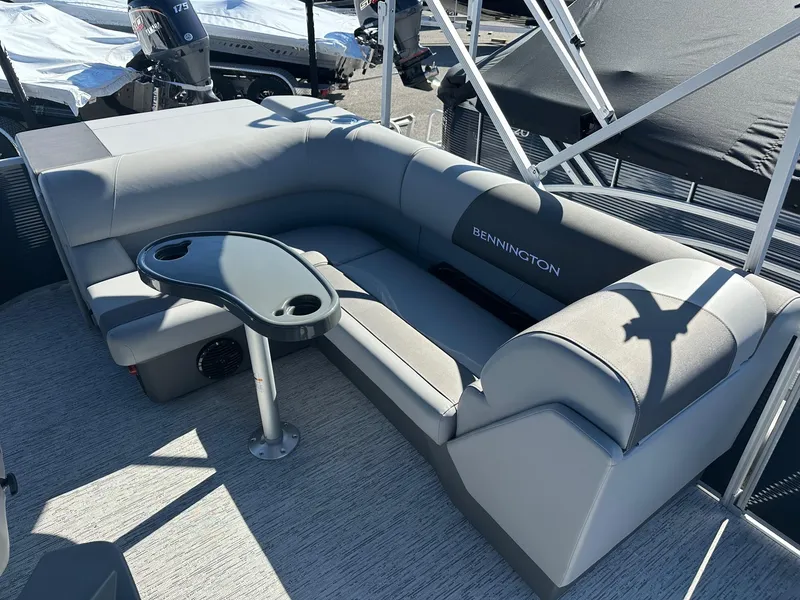 Slide: The Image of 2025 Bennington 20 SL Family pontoon boat interior with privacy room and seating area. - 6