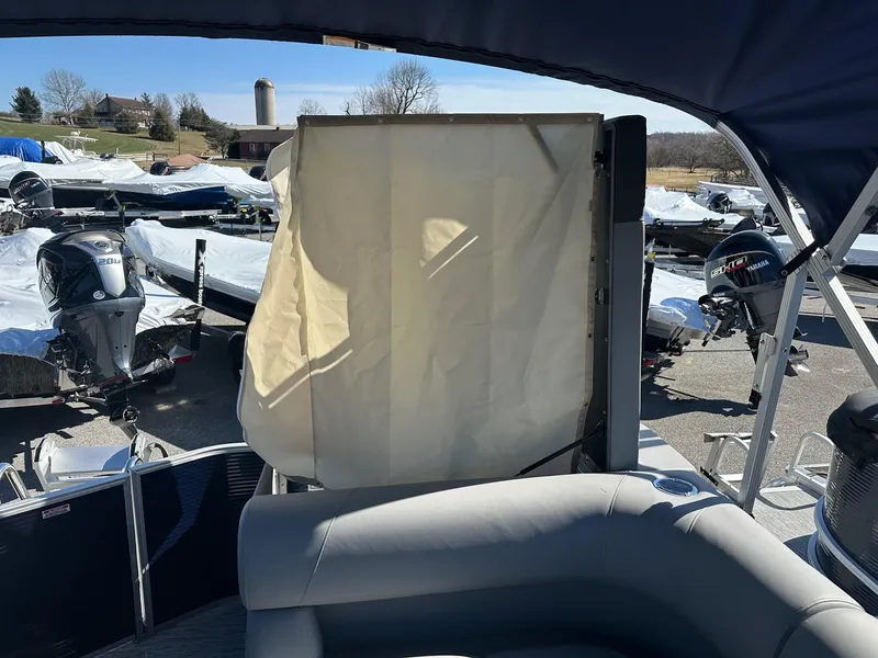 Slide: The Image of 2025 Bennington 20 SL Family boat with privacy room, parked outdoors. - 7