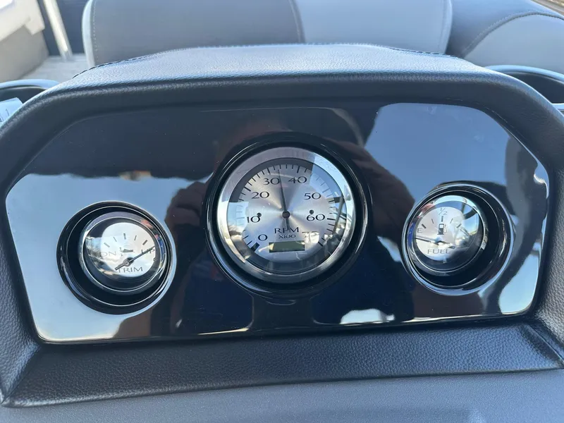 Slide: The Image of Dashboard of 2025 Bennington 20 SL Family boat with gauges for RPM, trim, and fuel. - 9