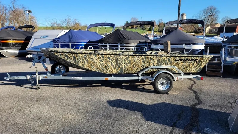 The Image of 2025 Smoker Craft Sportsman 1660 Tiller in Mossy Oak Camo on trailer. - 1