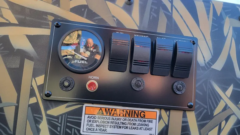 Slide: The Image of Control panel of 2025 Smoker Craft Sportsman 1660 with Mossy Oak Camo design. - 6