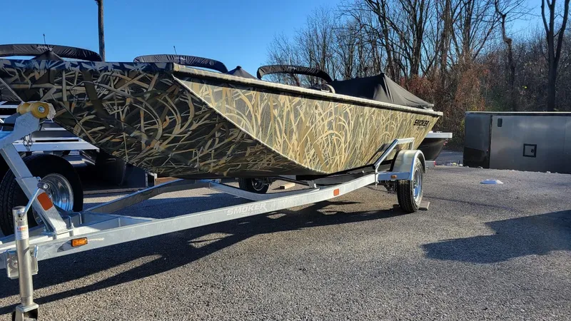 Slide: The Image of 2025 Smoker Craft Sportsman 1660 tiller boat in Mossy Oak Camo on trailer. - 7