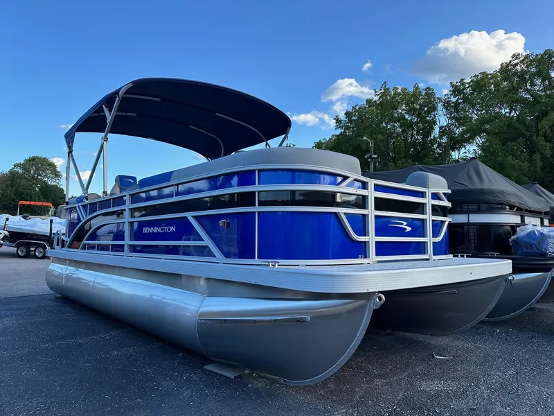 Slide: The Image of 2025 Bennington 21 SSR Quad Bench pontoon boat, blue exterior, in stock. - 1