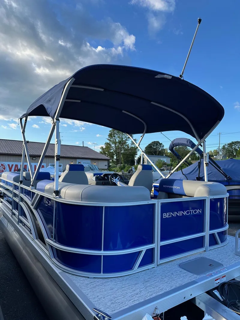 Slide: The Image of 2025 Bennington 21 SSR Quad Bench pontoon boat with blue canopy, in stock. - 14