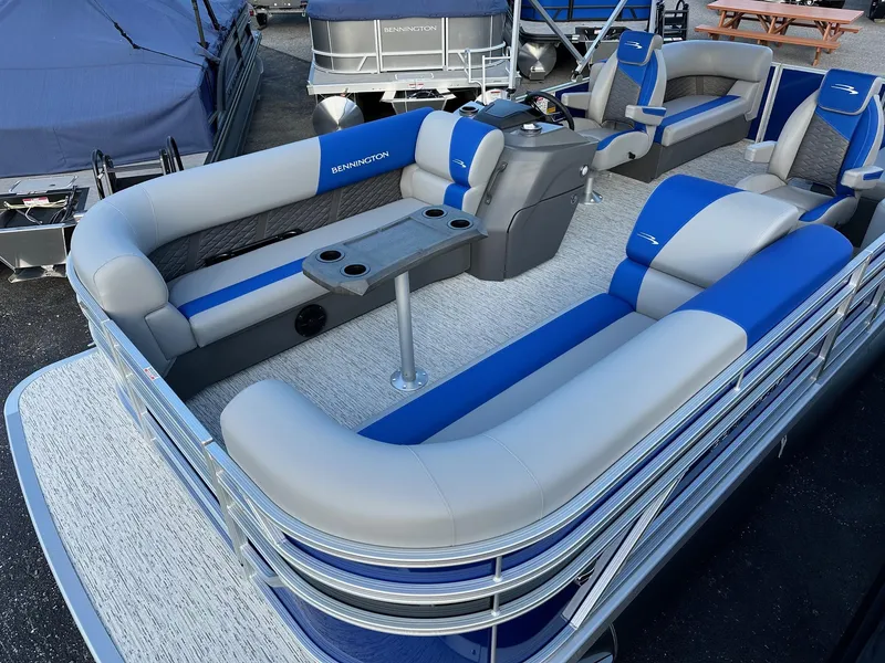 Slide: The Image of 2025 Bennington 21 SSR Quad Bench pontoon boat with blue and gray seating. - 17
