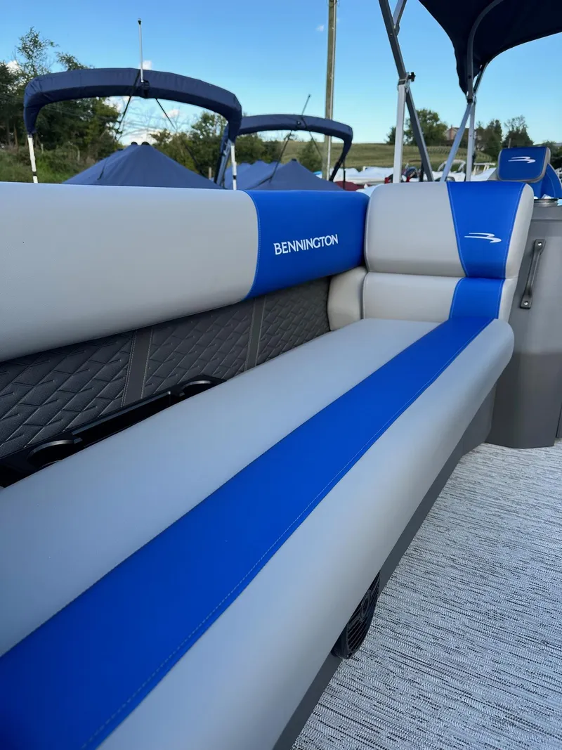 Slide: The Image of 2025 Bennington 21 SSR Quad Bench boat with blue and gray seating. - 18