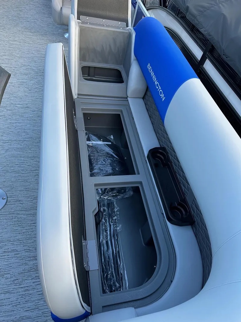 Slide: The Image of 2025 Bennington 21 SSR Quad Bench with open storage compartment, showcasing sleek design. - 19