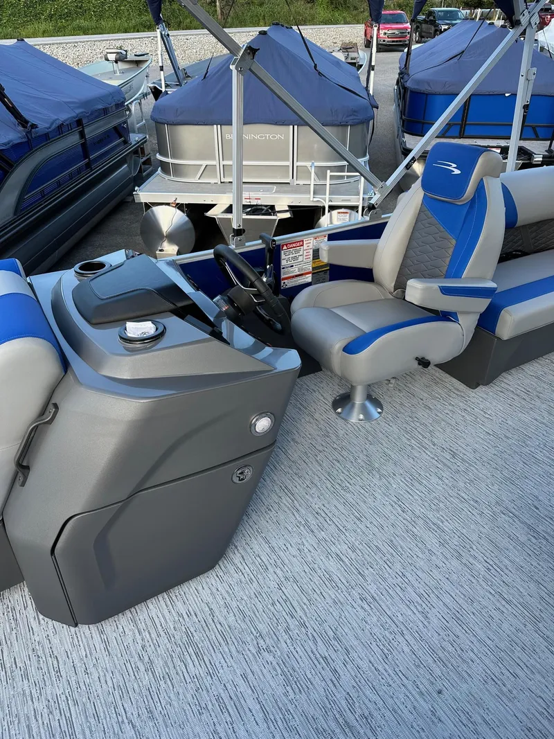 Slide: The Image of 2025 Bennington 21 SSR Quad Bench pontoon boat interior with blue and gray seating. - 20