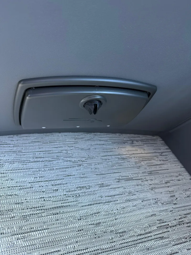 Slide: The Image of 2025 Bennington 21 SSR Quad Bench interior detail with textured upholstery and control panel. - 24