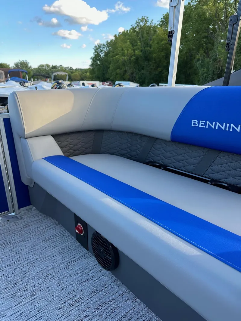Slide: The Image of 2025 Bennington 21 SSR Quad Bench boat interior with blue and gray seating. - 29
