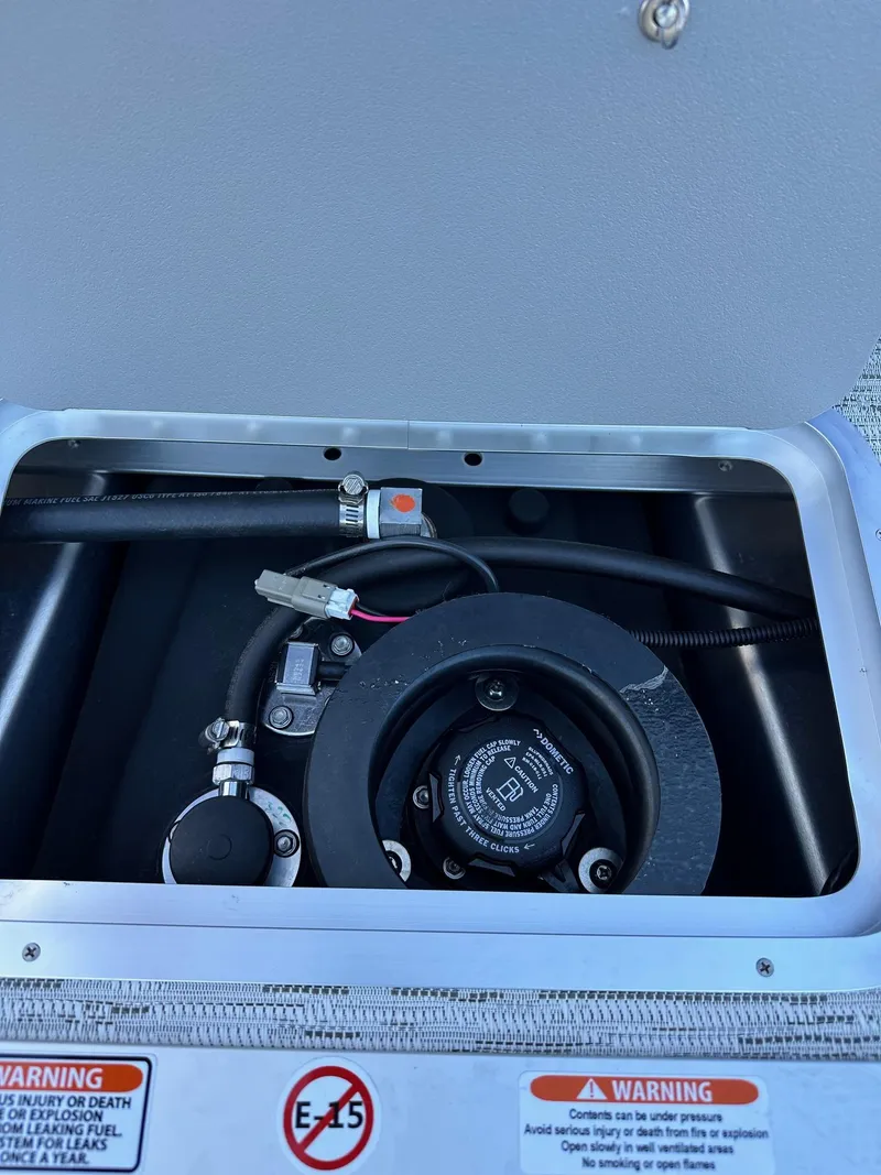 Slide: The Image of 2025 Bennington 21 SSR Quad Bench fuel compartment with safety warnings. - 32