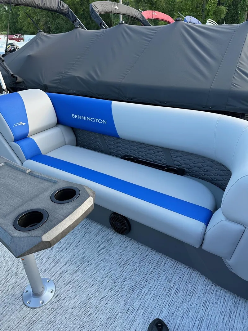 Slide: The Image of 2025 Bennington 21 SSR Quad Bench boat interior with blue and gray seating. - 7