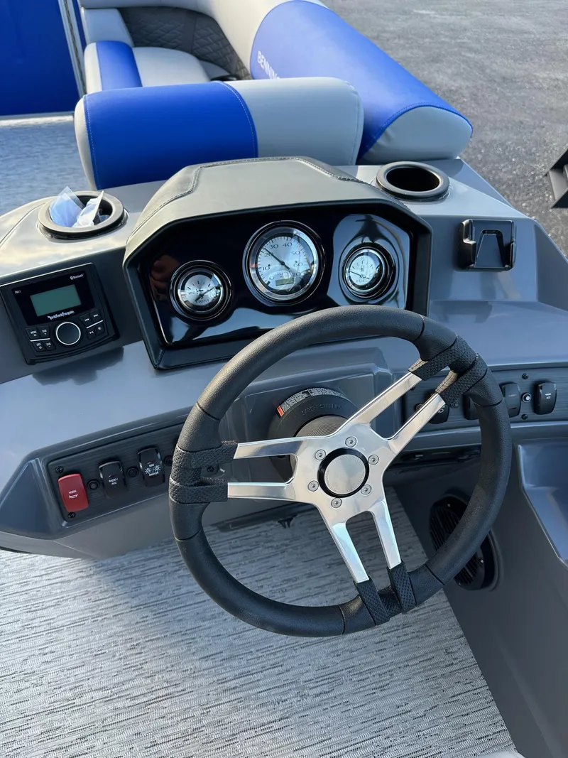 Slide: The Image of 2025 Bennington 21 SSR Quad Bench boat dashboard with steering wheel and gauges. - 8