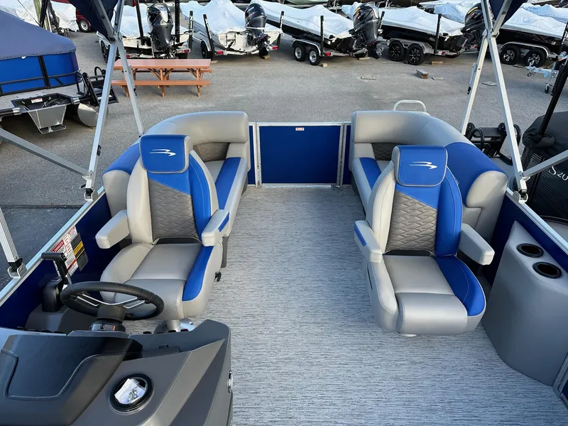 Slide: The Image of 2025 Bennington 21 SSR Quad Bench boat interior with blue and gray seating. - 9