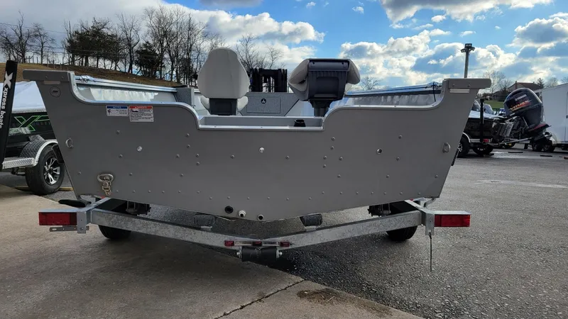 Slide: The Image of 2023 Smoker Craft Freedom 16 tiller deep V boat with Yamaha 50 hp engine on trailer. - 16