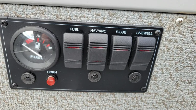 Slide: The Image of Control panel of 2023 Smoker Craft Freedom 16 boat with fuel gauge and switches. - 17