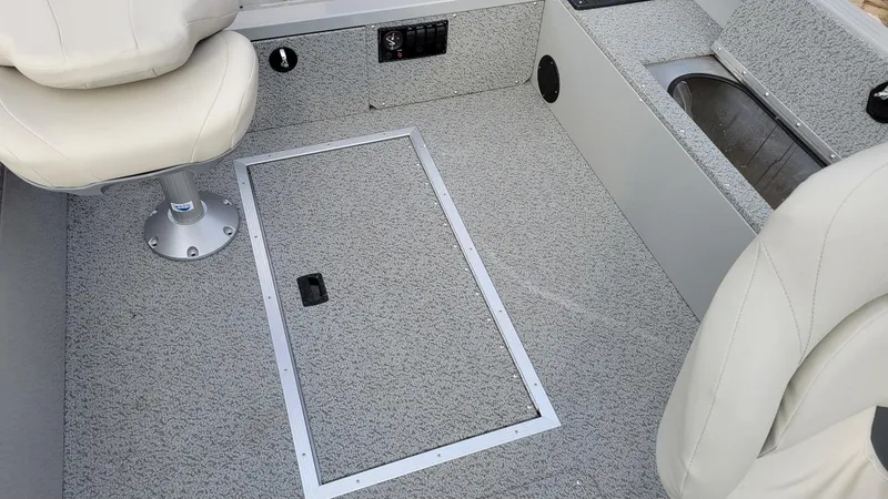 Slide: The Image of 2023 Smoker Craft Freedom 16 interior with seating and storage compartment. - 21