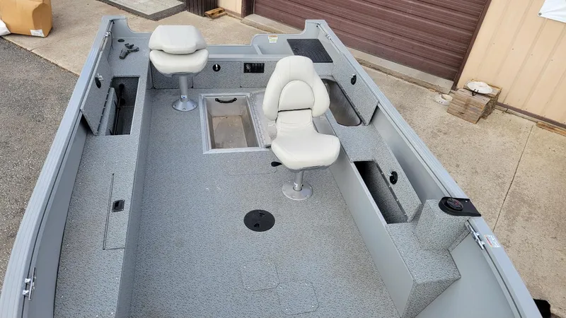 Slide: The Image of 2023 Smoker Craft Freedom 16 tiller boat interior with seating and storage compartments. - 6