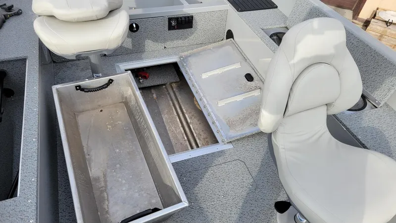 Slide: The Image of 2023 Smoker Craft Freedom 16 boat interior with storage compartments and seating. - 8