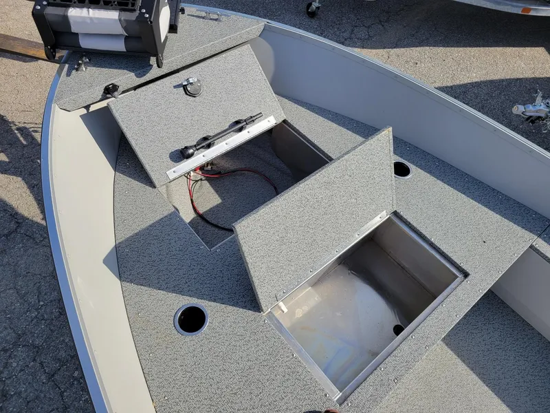 Slide: The Image of 2025 Smoker Craft 16' Angler Patriot Tiller fishing boat interior with storage compartments. - 5