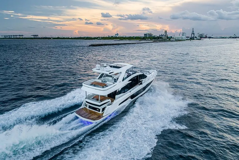 Slide: The Image of 2023 Galeon 680 Fly yacht cruising at sunset on open water. - 12