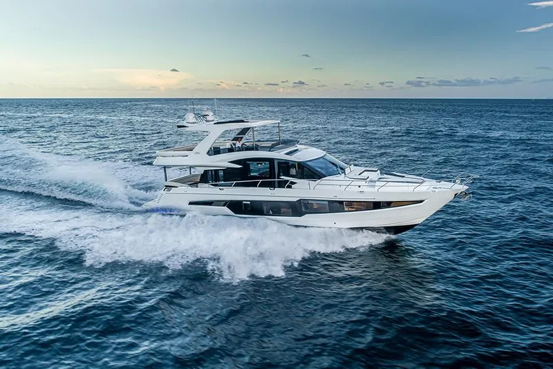 Slide: The Image of 2023 Galeon 680 Fly yacht cruising on open water at sunset. - 14