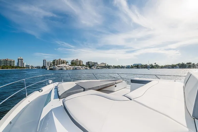 Slide: The Image of 2023 Galeon 680 Fly yacht on a sunny day with city skyline in the background. - 17
