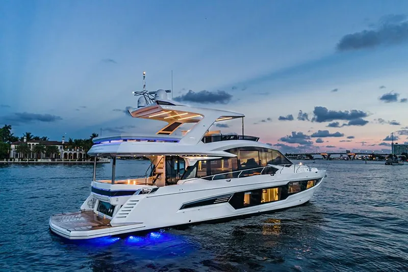 Slide: The Image of 2023 Galeon 680 Fly yacht at sunset on the water. - 2