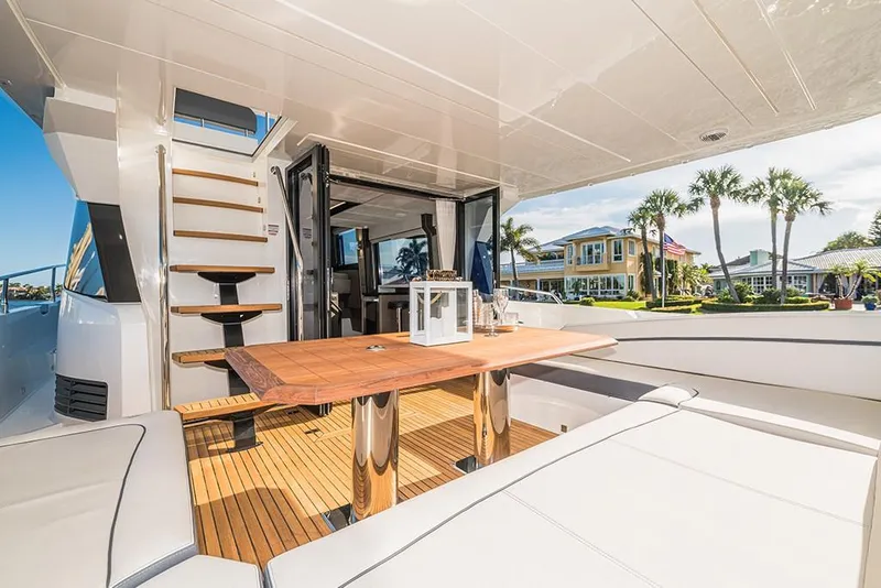 Slide: The Image of Luxurious 2023 Galeon 680 Fly yacht with spacious outdoor seating and dining area. - 22