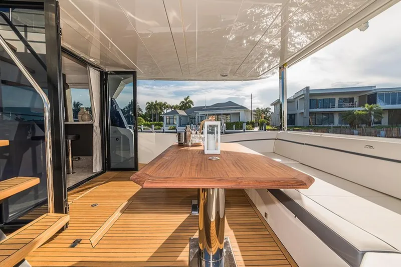 Slide: The Image of 2023 Galeon 680 Fly yacht, spacious outdoor seating area with wooden table. - 23