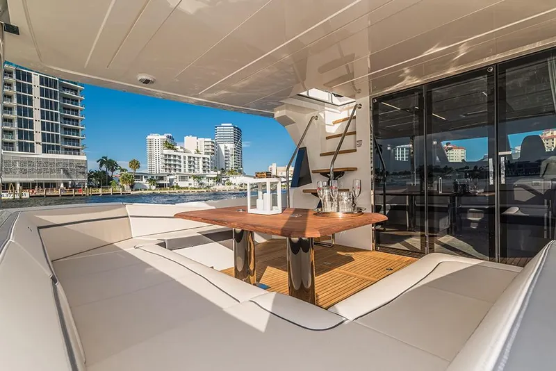 Slide: The Image of Luxury seating area on the 2023 Galeon 680 Fly yacht with cityscape view. - 24