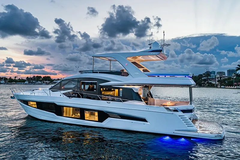 Slide: The Image of 2023 Galeon 680 Fly luxury yacht at sunset on the water. - 3