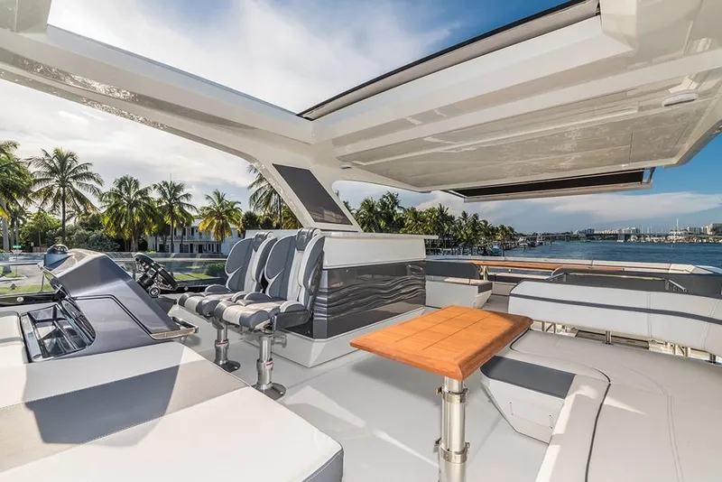 Slide: The Image of 2023 Galeon 680 Fly yacht flybridge with seating and table, overlooking waterfront. - 31
