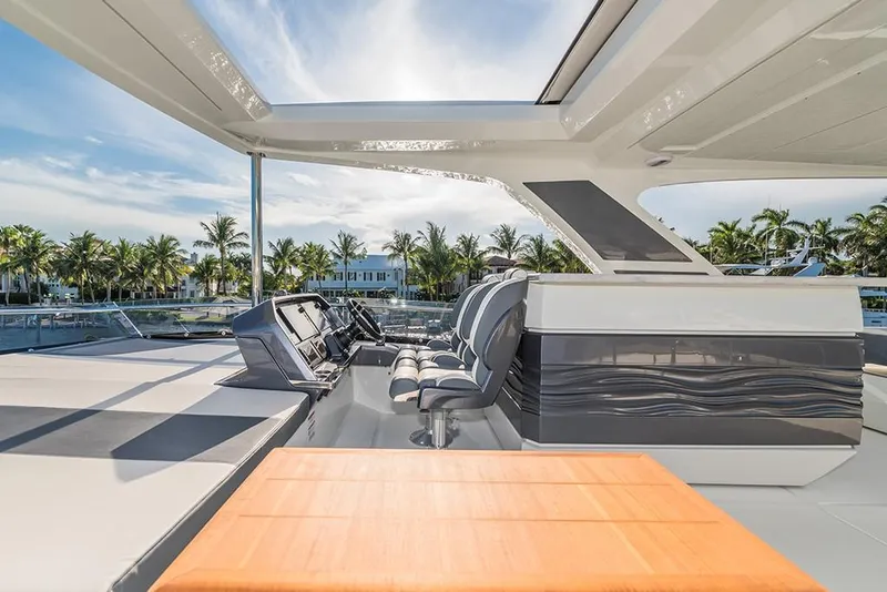 Slide: The Image of 2023 Galeon 680 Fly yacht flybridge with helm station and seating area. - 32