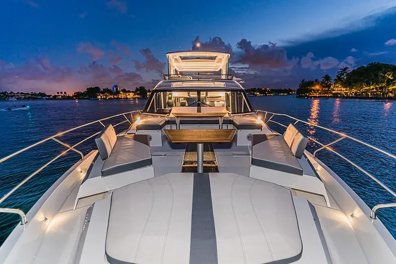 Slide: The Image of 2023 Galeon 680 Fly luxury yacht at sunset on the water. - 35