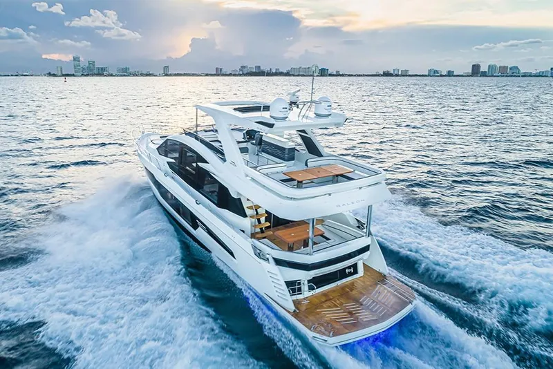 Slide: The Image of 2023 Galeon 680 Fly yacht cruising on open water at sunset. - 4