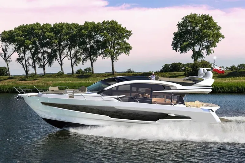 Slide: The Image of 2023 Galeon 700 Sky yacht cruising on a serene river with lush green trees. - 5