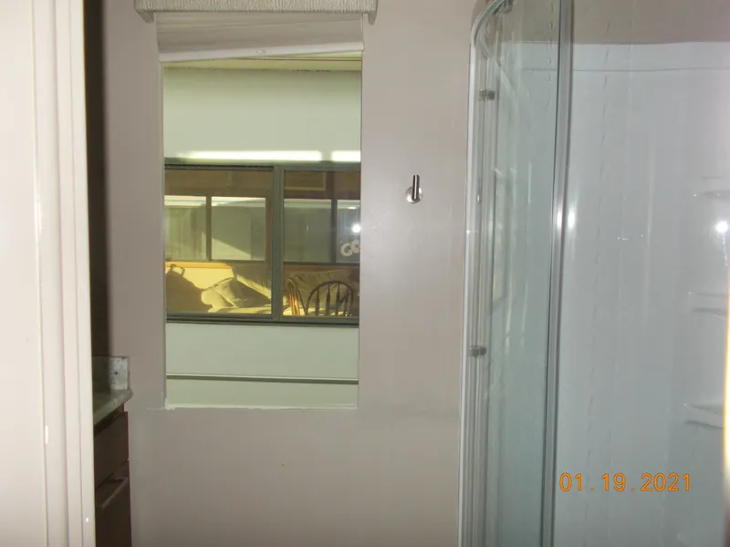 Slide: The Image of Bathroom with shower enclosure and window, taken on January 19, 2021. - 15