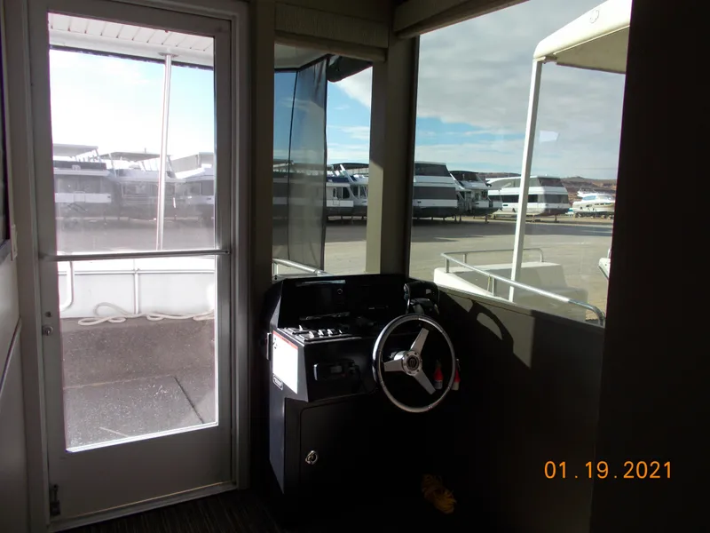 Slide: The Image of Bravada houseboat helm station in marina, 2021. - 16