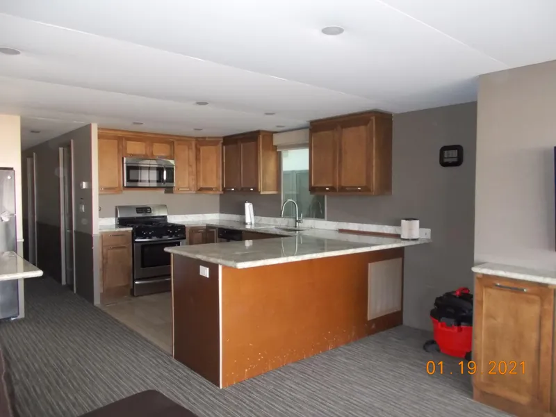 Slide: The Image of Modern kitchen in a 2015 Bravada Discovery Trip RV. - 19