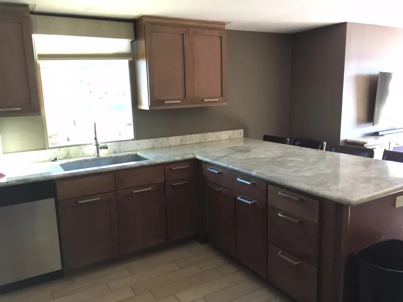 Slide: The Image of Modern kitchen with marble countertop and wooden cabinets, Bravada Discovery Trip 2026. - 5