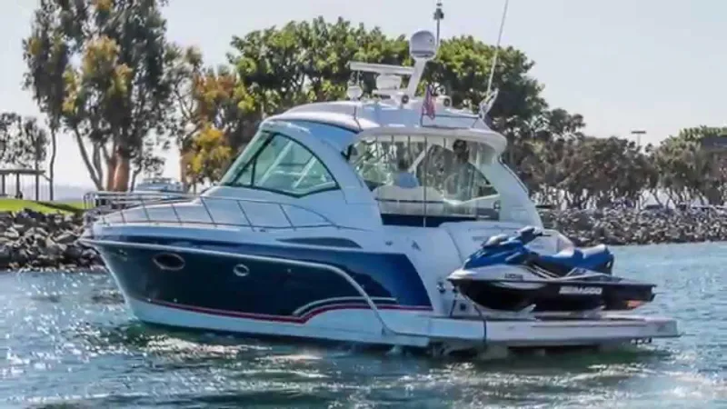 The Image of 2009 Formula 45 Yacht cruising with jet ski on calm waters. - 0