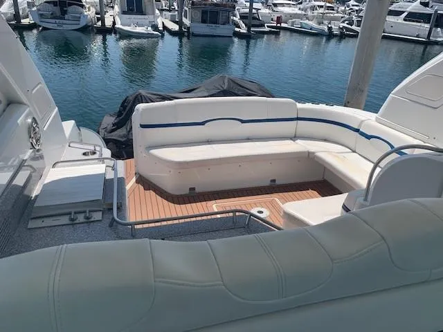 Slide: The Image of 2009 Formula 45 Yacht with white seating and wooden deck at marina. - 10