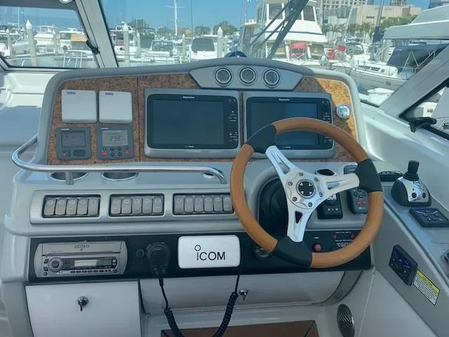 Slide: The Image of Control panel of a 2009 Formula 45 Yacht with steering wheel and navigation equipment. - 16