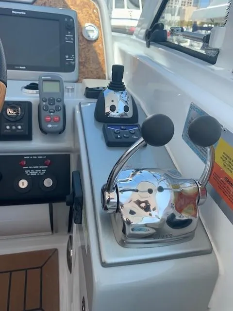 Slide: The Image of Control panel of a 2009 Formula 45 Yacht with navigation equipment and throttle levers. - 18